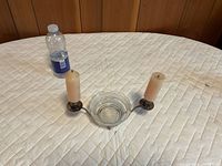 Double arm silver plated candle holder with central glass dish on table