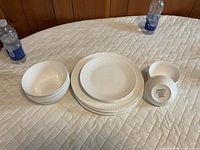 Full set showing plates and bowls; bottom mark visible on upturned bowl confirms Mikasa Bone China