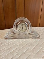 Front view of crystal mantel clock showing dial and cut pattern