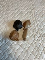 Four stone carved turtle figurines arranged on quilted surface
