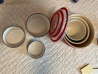 Top view of nested mixing bowls with lid plus three patterned bowls