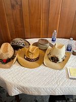 Five men’s hats arranged on table