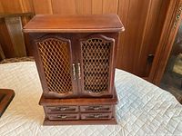 Front view closed showing twin mesh doors and four lower drawers
