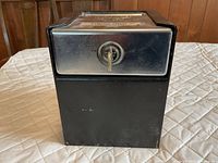 Front view of Perma-Vault drop safe showing key inserted in lock