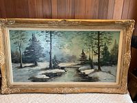 Front view of framed oil painting showing winter landscape scene