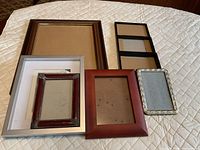 All six picture frames displayed on quilted surface