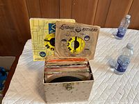 open record case showing stack of 45-RPM records in sleeves; visible London Records and MGM sleeves