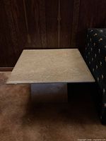 Square beige marble coffee table with pedestal base, full view