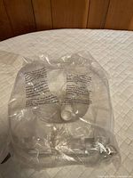 Packaged white plastic toilet seat sealed in clear bag