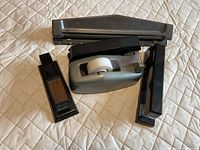 Group shot showing two staplers, hole punch, tape dispenser