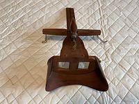 Top view of complete wooden stereoscope viewer with hood, handle, lenses, and wire card holder
