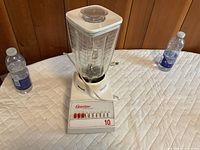 Blender base, glass jar, lid, power cord visible