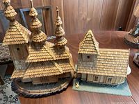 Both wooden model houses on table showing design and scale