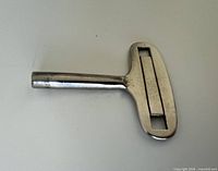 Full view of chrome-plated clock key front side