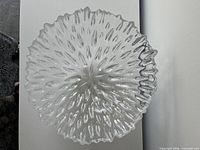 Top view of entire clear textured glass bowl showing ruffled edge