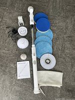 Full lot showing scrubber, heads, pads, charger, bag
