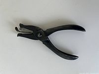 Full view right side of black steel hole-punch pliers