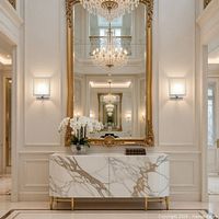 Staged interior showing two identical square wall sconces flanking a mirror, highlighting design and light diffusion