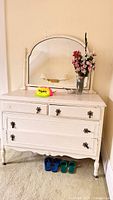 Front view of white dresser with mirror and turned legs