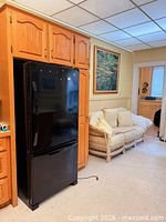 Front view of black Kenmore refrigerator in cabinetry cutout