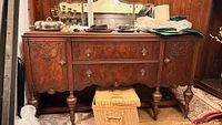 Front view of sideboard showing drawers, cabinets, hardware, mirror on top