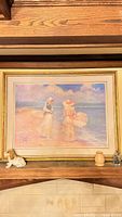 Front view of framed print on shelf