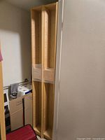 Front view of both tall light wood CD towers wrapped together