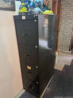 Front view of black 4-drawer filing cabinet