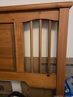 right side of headboard showing spindle detail and wood grain