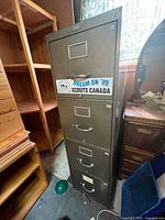 Full view of metal 4-drawer filing cabinet with Scouts Canada sticker