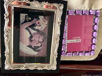 front of two tabletop photo frames