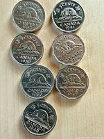 Reverse side showing beaver design and visible dates of all seven coins