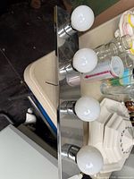Full view of chrome 4-bulb vanity light with bulbs attached