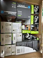 Box containing assorted packaged bulbs—overview