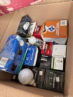 Overview of box showing multiple branded bulb boxes and loose bulbs
