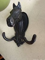 Front view of cast iron horse head wall hook with two hooks