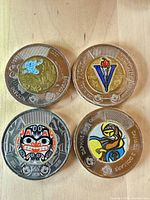 Obverse sides showing coloured designs of four commemorative $2 coins