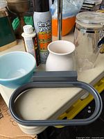 Group shot showing bag holder, cleaners, bowl, jar, ceramic piece