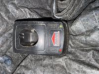 Top view of Jobmate charger base showing battery slot and LED indicators