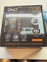 Front of QooWare COB LED strip light box showing specifications