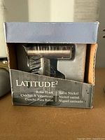 Front of Gatco Latitude² robe hook box showing product name and finish