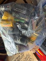 Bag containing assorted rechargeable batteries of various sizes and brands