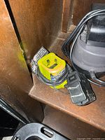 Front and top view of Ryobi battery charger showing shape, color and cord