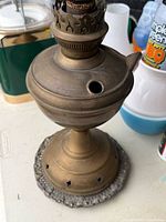 brass kerosene lamp showing burner and side fill port