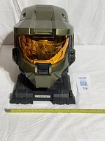 Front view of helmet on assembled base, measuring tape visible