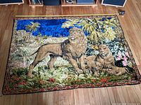 Full view of tapestry showing lion family scene and border