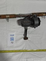 Close view of Ocean Star No.36 reel on rod with tape for scale