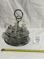 Full view of chrome stand with four glass bottles