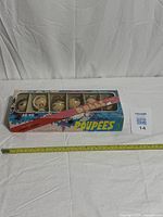 full boxed set of five dolls beside tape for scale