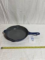 Top view of skillet with tape measure indicating diameter